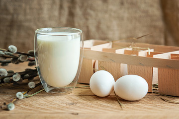 Ingredients for baking Easter cake - eggs, milk on wooden background