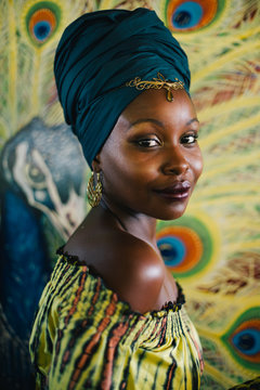 Beautiful african hippie portrait in yellow dress and blue turban