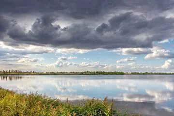 Foto op Canvas A river and the dramatic cloudscape after the rain. weather change © sosiukin