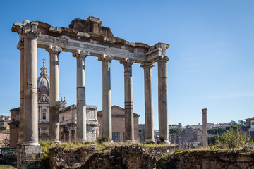 Fototapeta premium ruins of Temple of Saturn at Roman Forum with blue sky