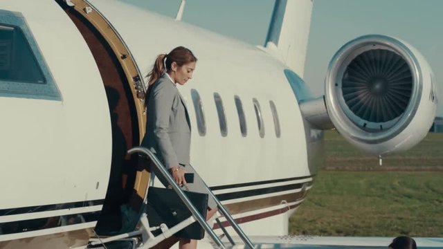  VIP Businesswoman disembarking from private luxury plane