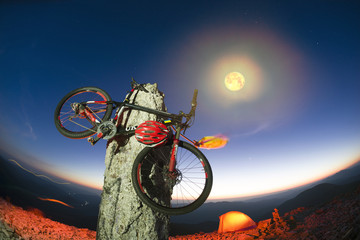 bike on a stone pillar tops at night