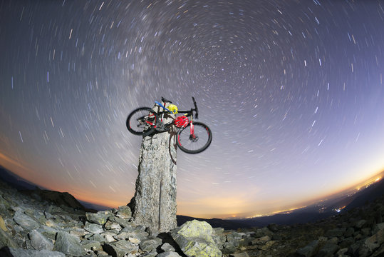 bike on a stone pillar tops at night