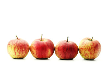Red apples in line on a white background