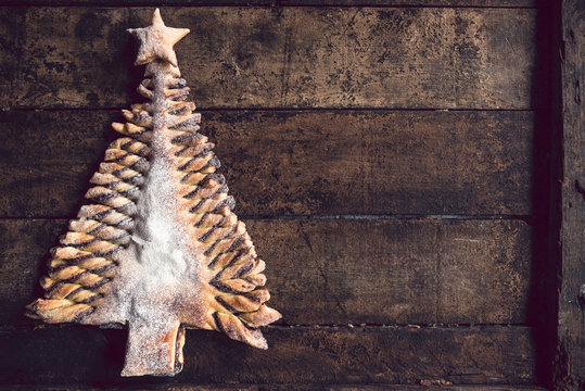 Chocolate Christmas tree on wooden background with blank space