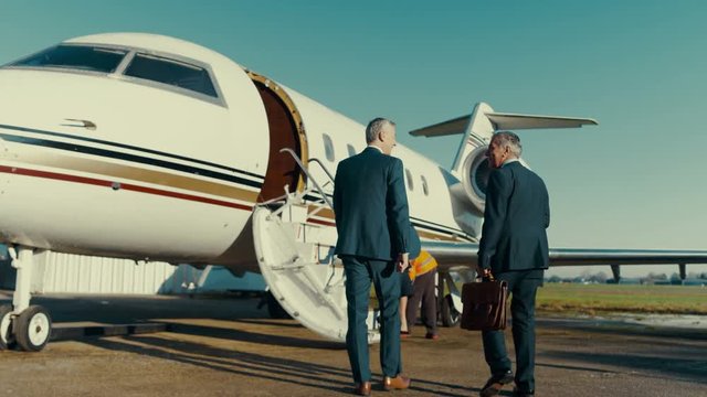  Mixed ethnicity VIP Businessmen boarding private jet