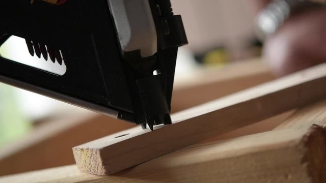 Nail Gun in Action Closeup Footage in Slow Motion. Construction Tools.