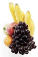 Vitamins, bowl of fruit: apples, orange, bananas and red grapes