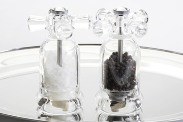 Salt and pepper mill on silver tray