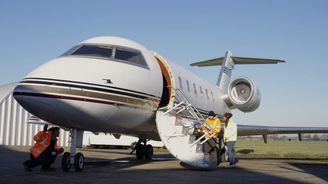 Time lapse of ground crew checking private plane before or after a flight