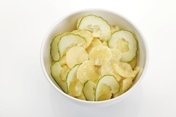 Bowl of cucumber and potato salad with oil and vinegar dressing