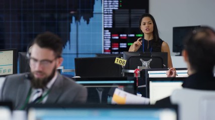  Manager in busy stock exchange overseeing staff & keeping them motivated