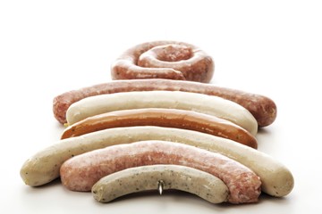Raw skewered bratwursts, various kinds