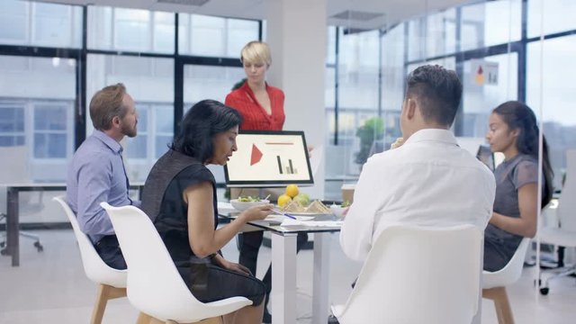  Corporate business team in early morning meeting with food & refreshments