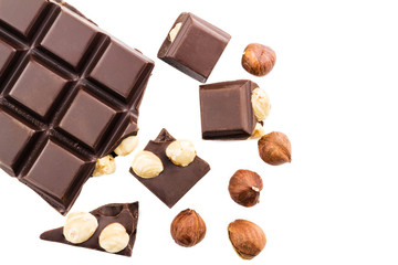 Pieces of bitter dark chocolate cubes with hazelnut isolated on white background, top view