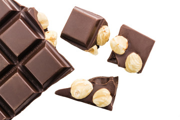 Pieces of bitter dark chocolate cubes with hazelnut isolated on white background, top view