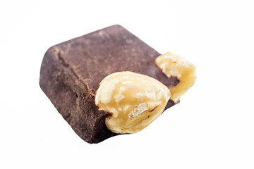Bitter dark chocolate cube with hazelnut isolated on white background