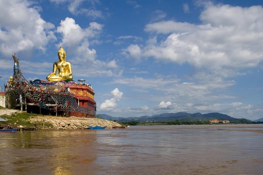 Buddha statue on the side of a river, Mae Salong, Thailand, Southeast Asia, Asia