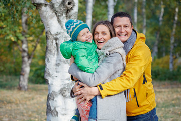 Happy family playing in autumn park