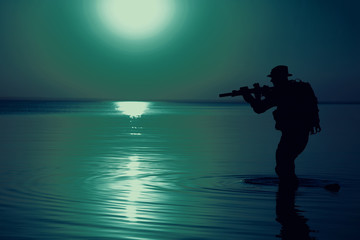 Army soldier with rifle night moon silhouette under cover of darkness. Covert diversionary operation