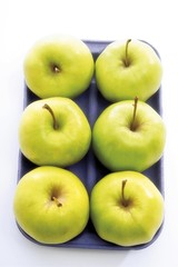 Green apples in plastic tray packaging
