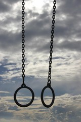 Gymnastic-rings in front of clouds