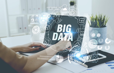 Woman typing at laptop keyboard, big data hologram