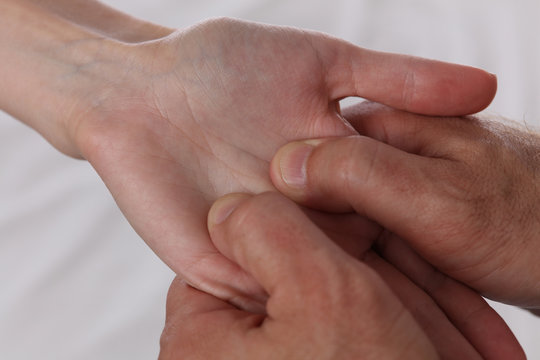 Acupressure. Therapist doing healing treatment on patient's hand . Alternative medicine concept