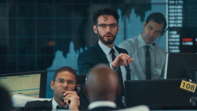  Manager in busy stock exchange overseeing staff & keeping them motivated