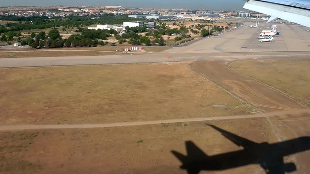 view of landing in an airport at sunrise from passenger window