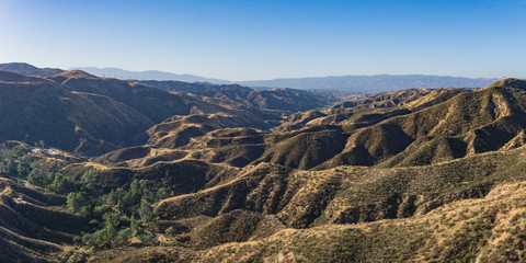 Long dry hills sweep down to a southern Californian canyon.