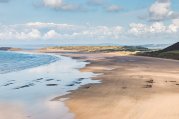 Low tide on a huge, empty sandy beach