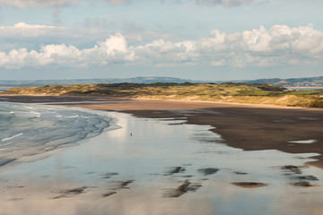 Late afternoon at low tide on a large, sandy beach