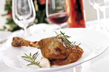 Leg of roast goose on a white plate