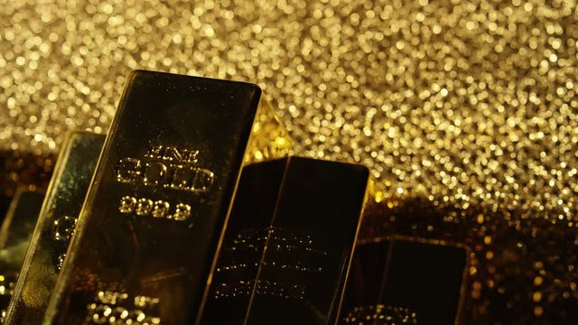  Close up gold bars on shimmering rotating stand, wealth & luxury concept.