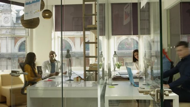  Time lapse casual business team working & brainstorming in creative office