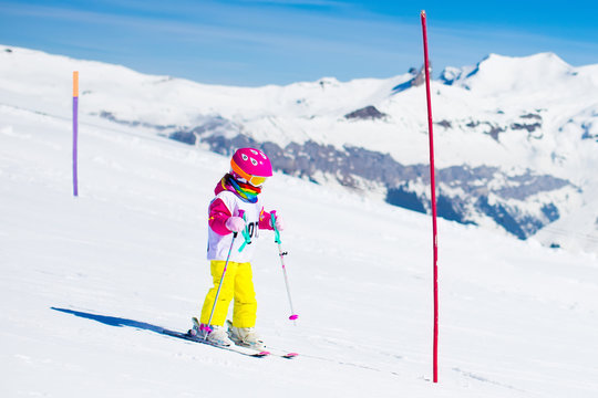 Ski and snow fun. Child in winter mountains.