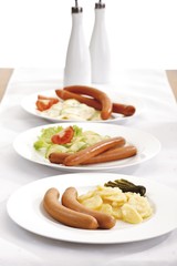 Sausages with potato salad on a plate