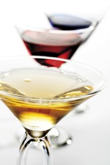 Three cocktail glasses with liqueur: Peach Liqueur, Blue Curacao and Red Orange
