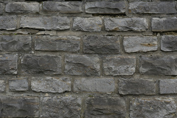 mauer aus stein mit groben steinen in grau als hintergrund