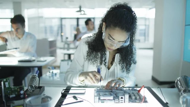  Technicians working in modern lab building electronics & robotics