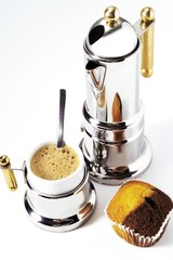 Cup of espresso, a piece of marble cake, and a silver espresso pot