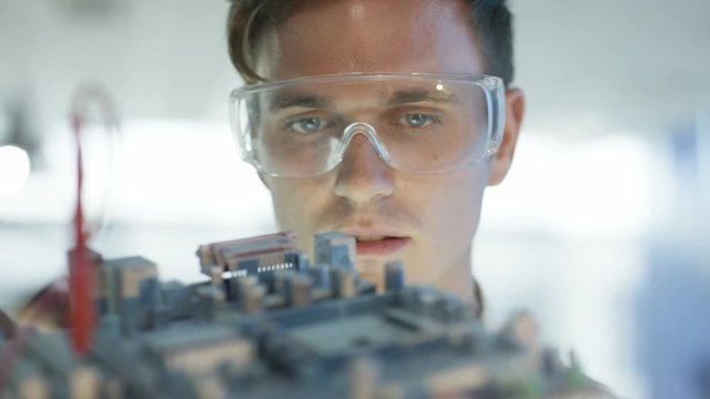  Close up electronics engineer working in lab building & testing motherboard. 