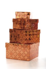 Four copper-coloured gift boxes, stacked
