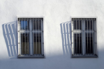 Barred windows with shadows