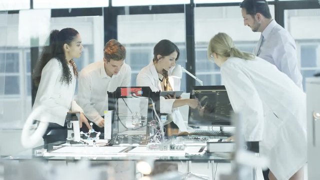  Scientific research engineers working in lab with computer & 3D printer