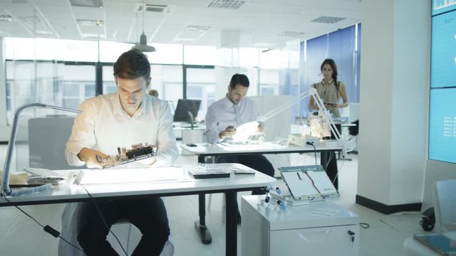  Technicians working in modern lab building electronics & robotics