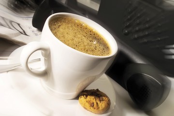 Cup of coffee, telephone in background