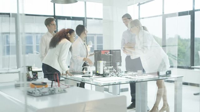  Scientific research engineers working in lab with computer & 3D printer