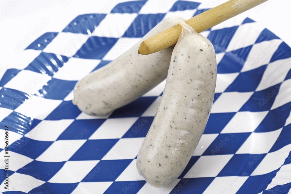 Wall mural A pair of Bavarian white sausages on a paper plate imprinted with Bavarian flag design